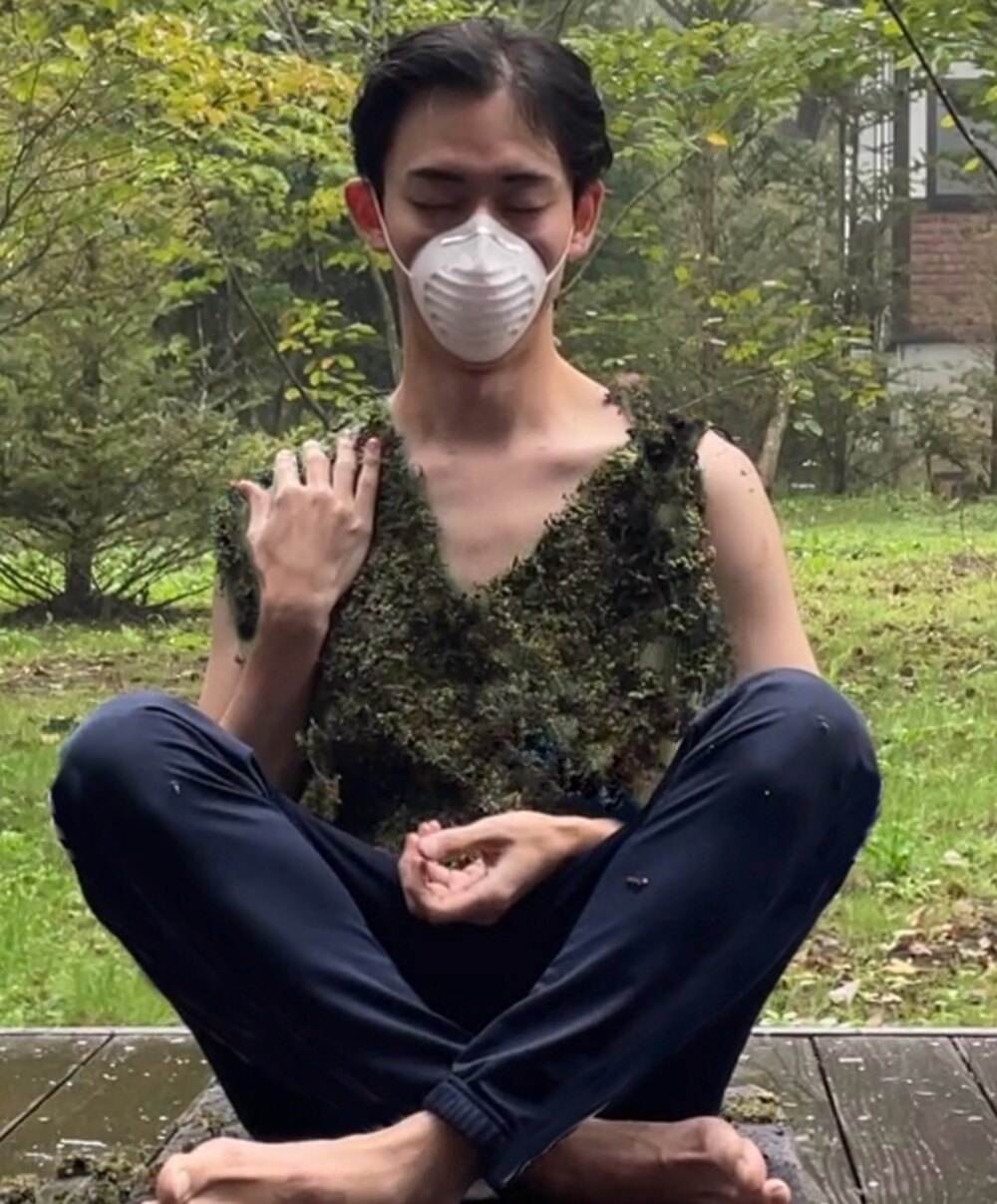 The moss vest worn during a seated test, with a dust mask